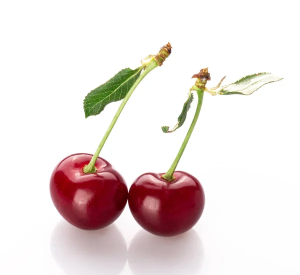 stock image fresh cherry berries with a green leaf isolated on a white background