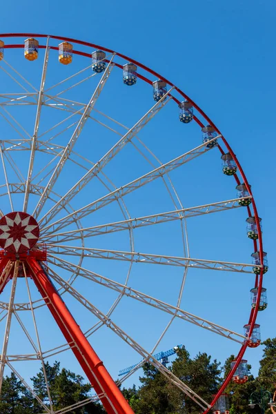 Ferris wheel on background of blue sky in Gorky Park. Kharkov, Ukraine