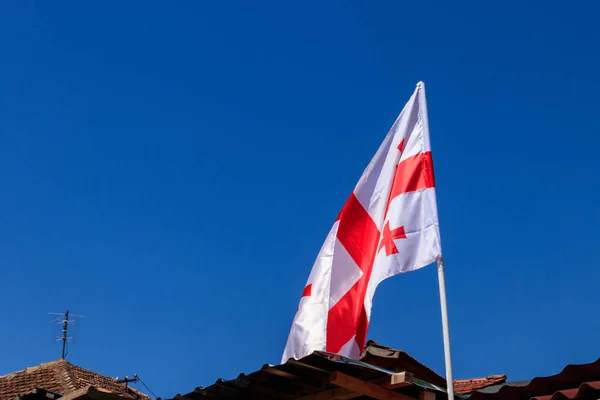 Georgian flag against blue sky