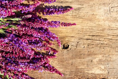 Mor ada çayı çiçekler rustik ahşap zemin üzerinde. Üstten görünüm, kopya alanı