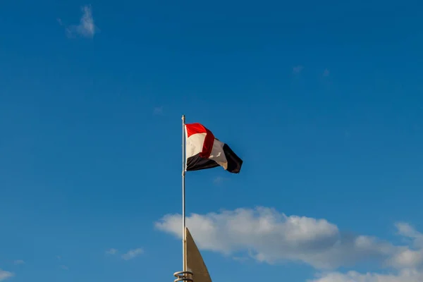 Egyptian flag on the blue sky background