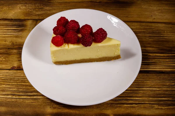 Piece Tasty New York Cheesecake Raspberries White Plate Wooden Table — Stock Photo, Image