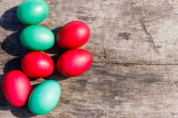 Painted Easter eggs on rustic wooden background — Stock Photo, Image