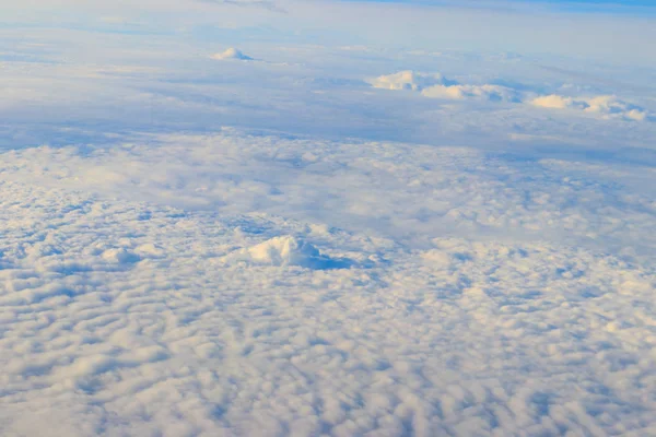 Beautiful white clouds in blue sky. View from airplane — Stock Photo, Image