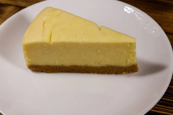 Bit läckra söta New York cheesecake i en vit tallrik — Stockfoto