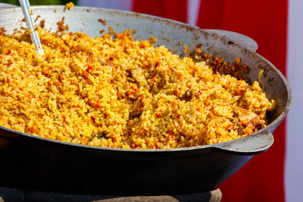 Cooking of pilaf with meat and spices