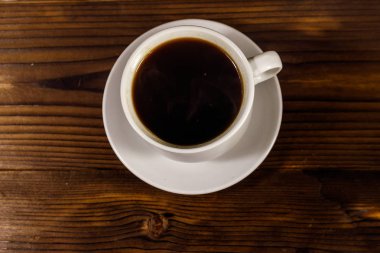 Tahta masada bir fincan kahve. Üst görünüm