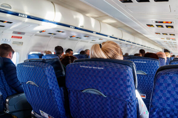 Interior of the airplane with passengers on seats