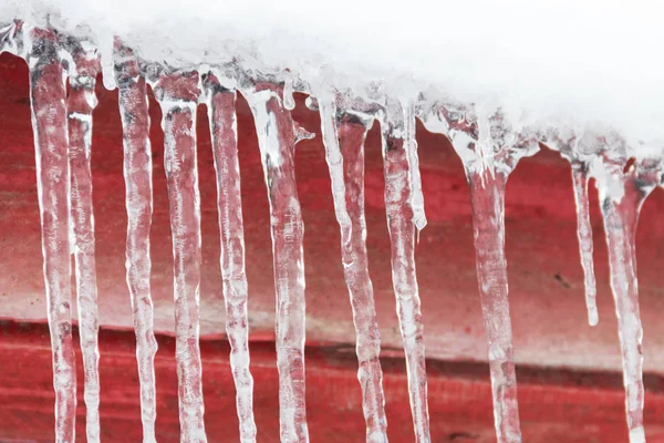 Icicles hanging from roof — Stock Photo, Image