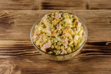 Sosis, bezelye, havuç ve soğan ahşap masa üzerinde mayonez salatası