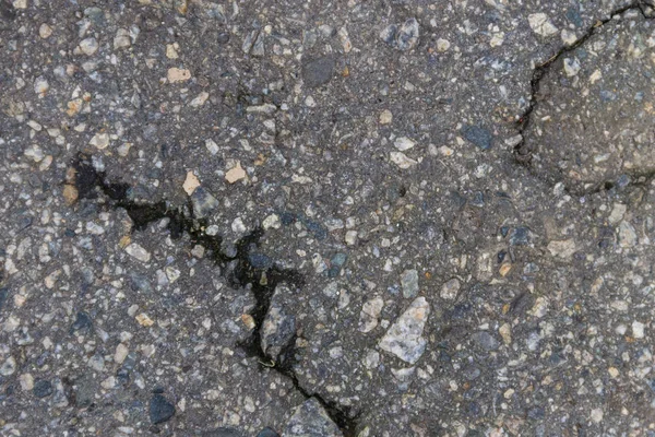 Textur med sprickor på asfalt bakgrund — Stockfoto