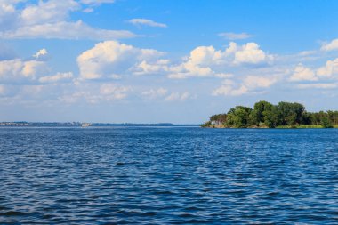 Güzel gölü, yeşil ağaçları ve mavi gökyüzü olan yaz manzarası.