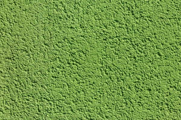 Декоративна зелена штукатурка на стіні. Текстура зеленої ліпнини для фону — стокове фото
