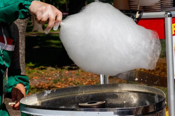 Making white cotton candy in cotton candy machine close-up