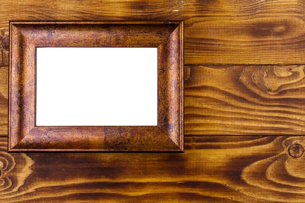 Empty photo frame on wooden background. Top view