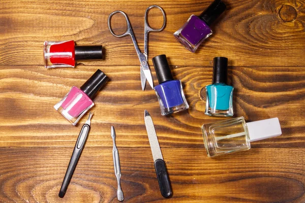 Basic set of manicure tools on wooden background