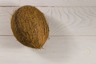 Beyaz ahşap masadaki hindistan cevizi.