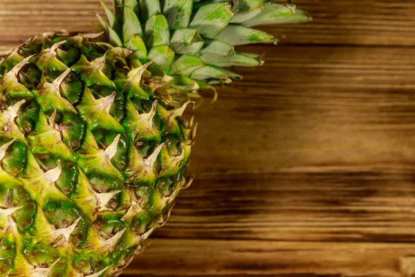 Whole pineapple on wooden table. Top view — Stock Photo, Image