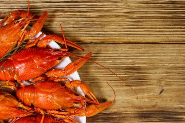 Ahşap masada kaynamış kerevit tabağı. Üst görünüm