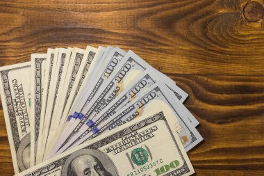 Tahta masadaki 100 dolarlık banknotlar