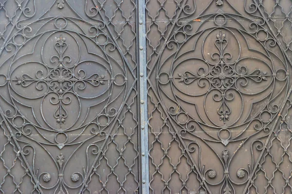 Forged metal door with decoration in a shape of an orthodox cross