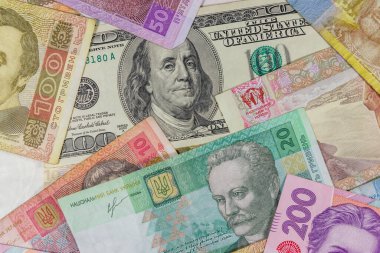 Ukrayna Hryvnia banknotlarının arka planında 100 dolarlık banknot