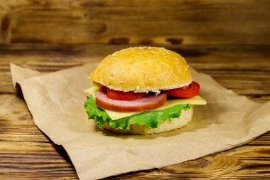 Taze nefis ev yapımı çizburger kahverengi kağıt üzerinde ahşap masa üzerinde