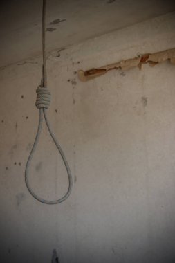 Terk edilmiş dairenin tavanından sarkan ölümcül döngü. İntihar kavramı, umutsuzluk.