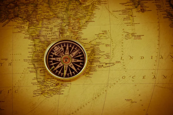 Compass on a vintage world map. Retro style