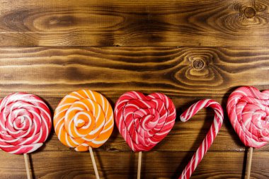 Kırsal ahşap arka planda tatlı lolipoplar. Üst görünüm