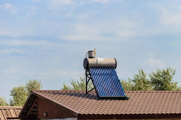Solar water heater on a residential house rooftop. Renewable energy for house