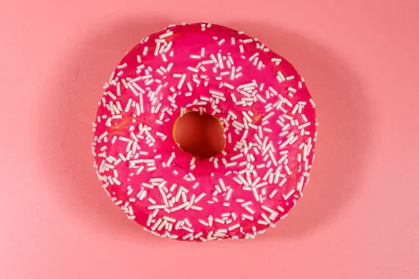Tasty pink donut on pink background