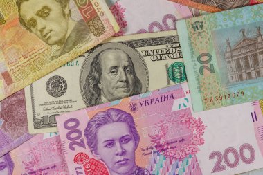 Ukrayna Hryvnia banknotlarının arka planında 100 dolarlık banknot