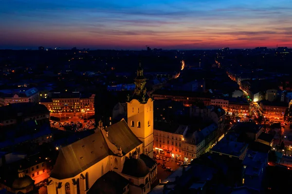 Aerial night view of illuminated Latin cathedral and Rynok square in Lviv, Ukraine. View from Lviv town hall