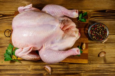 Ahşap bir masada baharatlı bütün bir tavuk. Üst görünüm