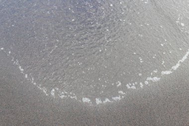 Ocean wave at black sand beach on Tenerife, Canary islands, Spain