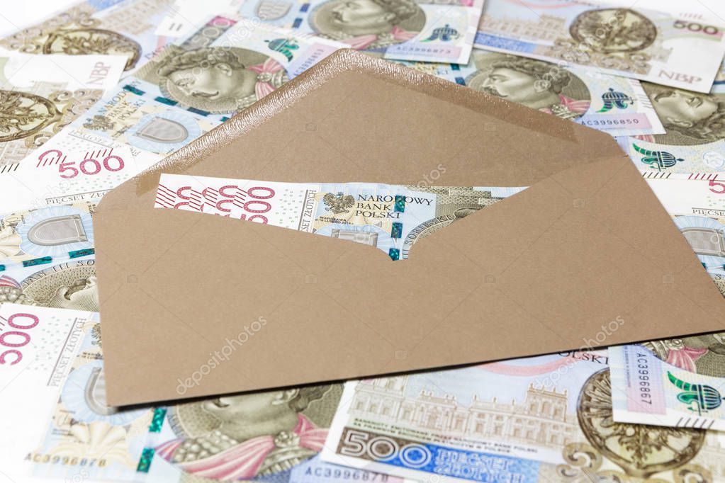 Brown envelope with 500 PLN banknotes on banknotes background