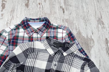 Ahşap arka plan üzerinde iki kareli gömlek. Moda kavramı