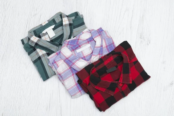 Green, red and lavender plaid shirts. Fashionable concept