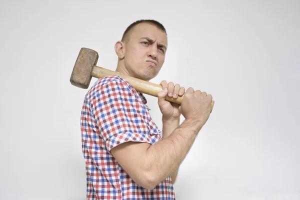 Man with a sledgehammer on a white background. Work concept