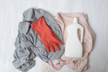 Giysi, lastik eldiven ve deterjan ile şişe. Üstten görünüm