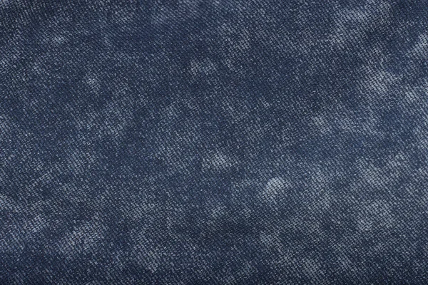 Solid background of blue denim. Close-up. Texture