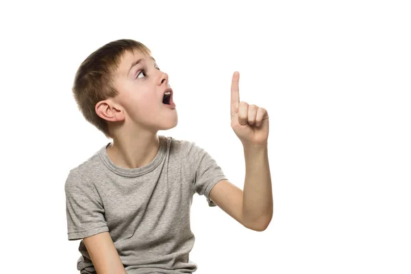 Surprised Fair Haired Boy Gray Shirt Stands Points Index Fingers — Stock Photo, Image