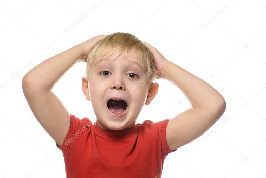 Screaming blond boy in a red t-shirt folded his arms behind his head. Isolate on white background
