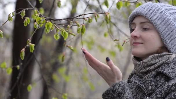 Girl Admires Touches Blossoming Leaves Her Fingers Wet Snow — Stock Video