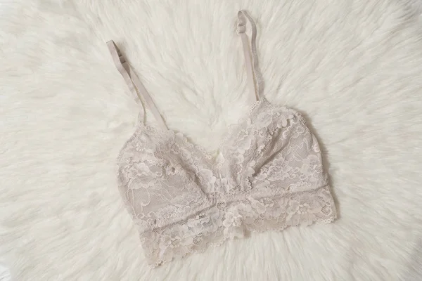 Soutien-gorge en dentelle rose clair sur fourrure blanche. Concept lingerie mode . — Photo