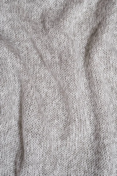 Struktura pleteného svetru ze šedé vlny. Close-up. Záhyby — Stock fotografie