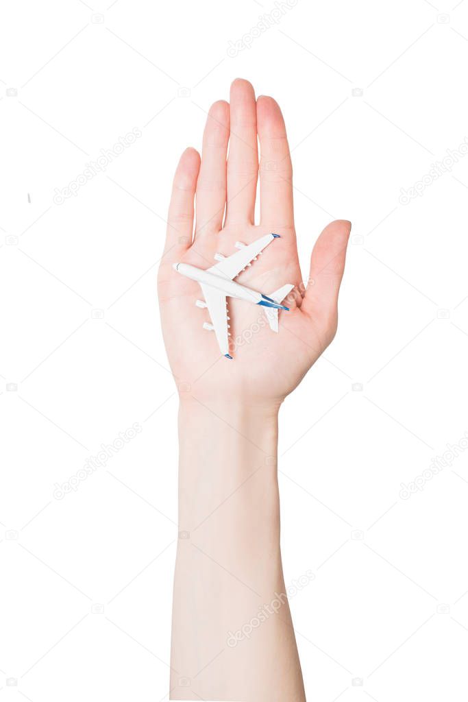 Plane on the female palm isolate on white background. Concept of safe flights