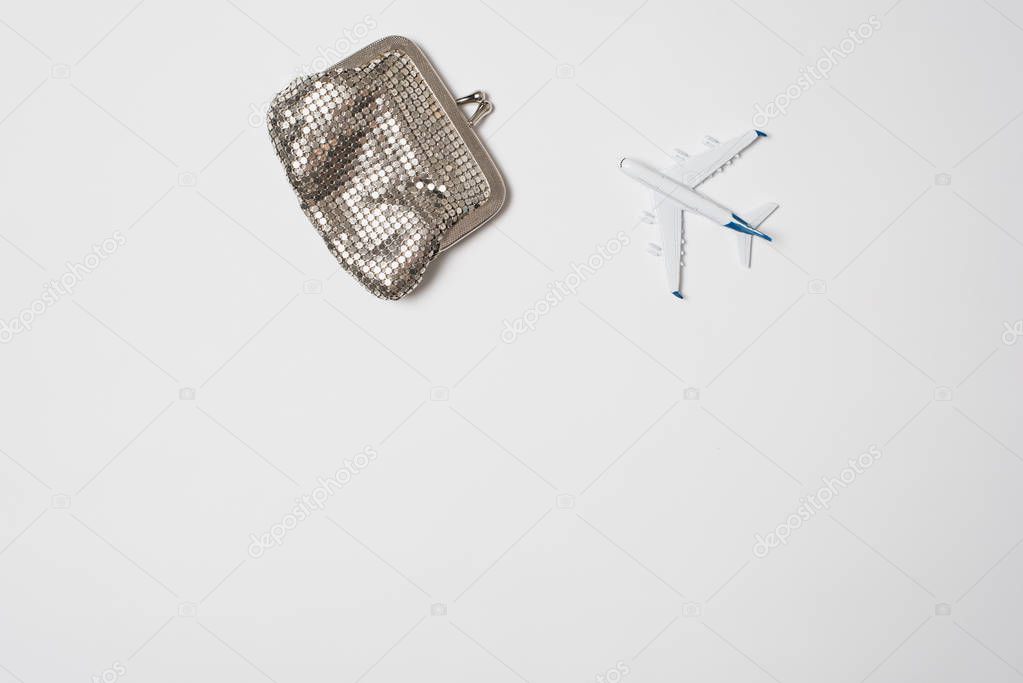 Passenger plane and wallet on a light background. Booking concept