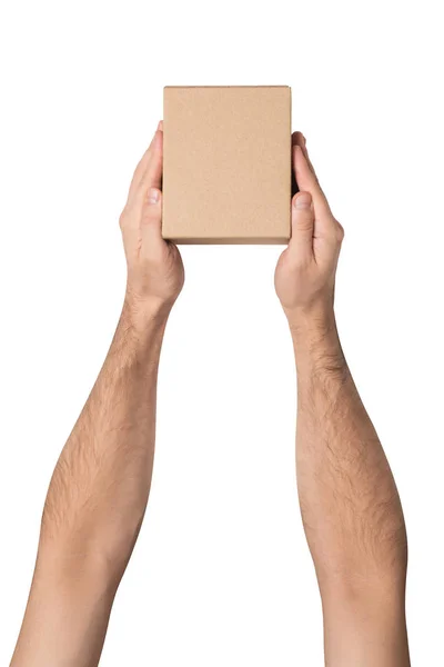 Kleines Päckchen in männlicher Hand. Ansicht von oben. weißer Tisch auf dem Hintergrund — Stockfoto